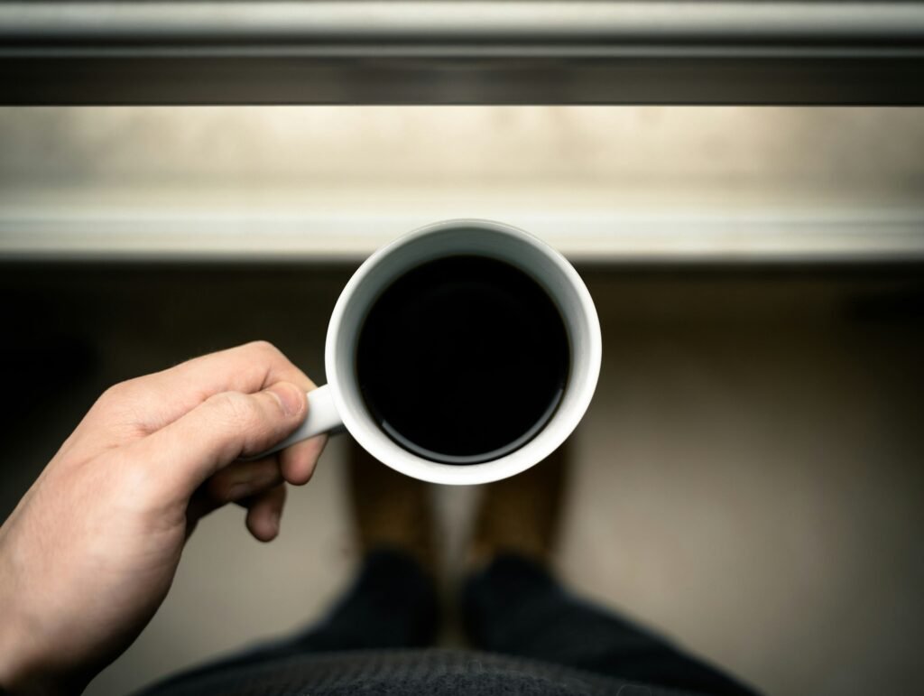 Black coffee in a white cup – writer’s fuel while answering book FAQ questions