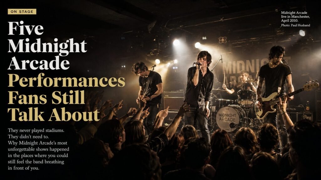 Midnight Arcade performing live on stage in front of a packed theatre audience, with Ben Carter singing under warm stage lights as Ryan Hale plays lead guitar. Fans reach towards the stage during one of the band’s unforgettable live performances.